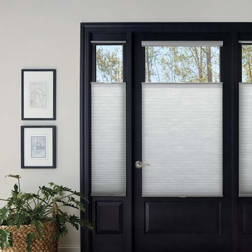 entryway door with gray window shades on sidelights