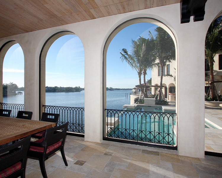 arched openings of patio with built-in exterior screen shades