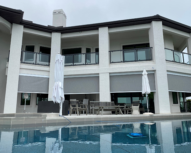 screen shades on lower part of house with patio