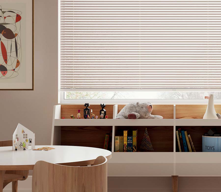 kids playroom with books and toys and beige blinds in Omaha, NE