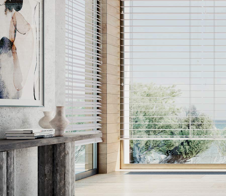 detail of primary bedroom corner windows with white horizontal blinds