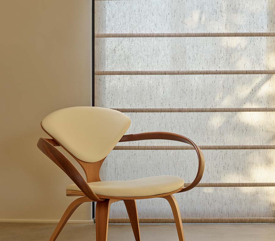 midcentury modern chair next to fabric window shades