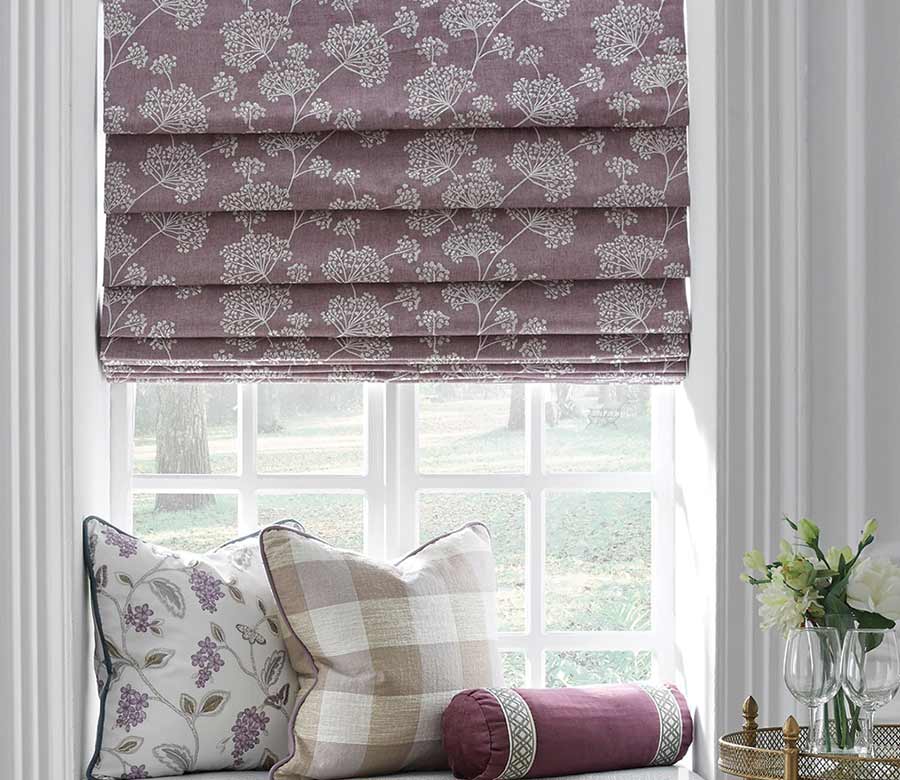 hobbled roman shades in lavender fabric with floral design with coordinated custom pillows