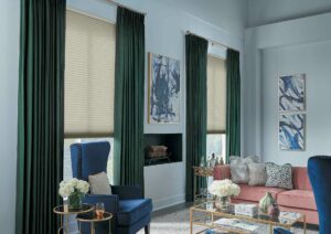 green velvet curtains over honeycomb shades in Omaha home