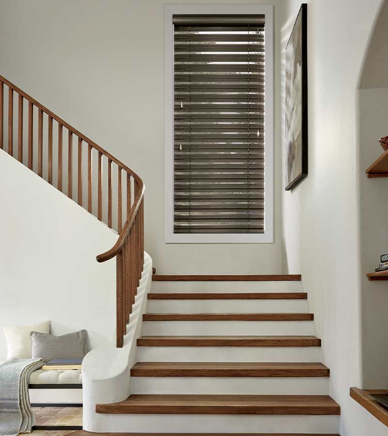 entryway stairs with mocha brown metal blinds in traditional Omaha, NE home