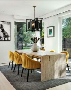 A neutral living room with mustard colored chairs under a neutral bedroom