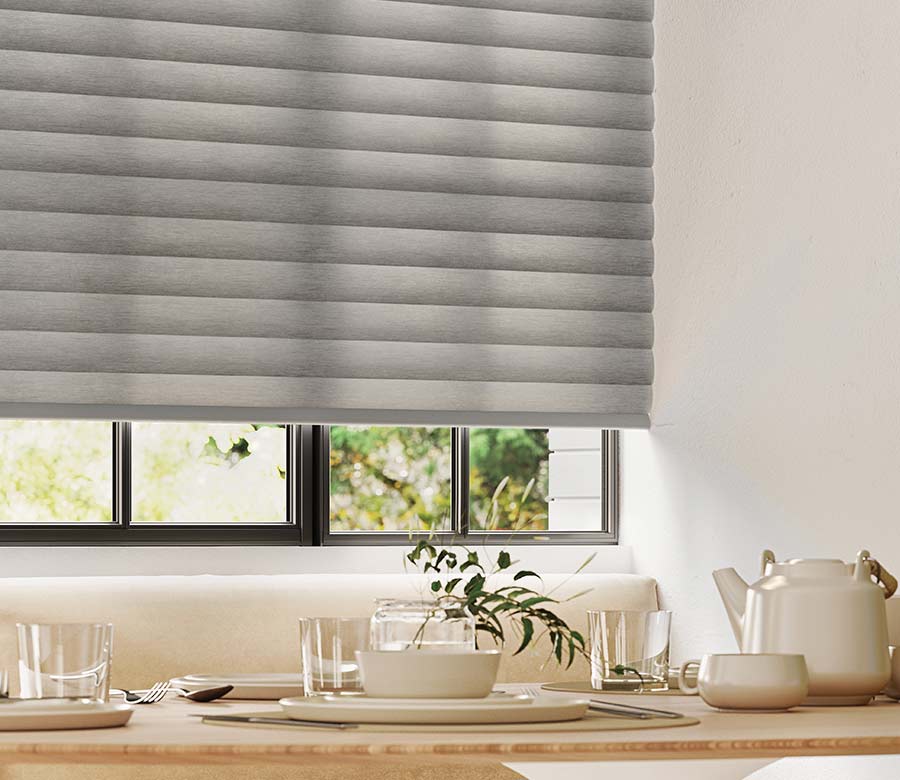 close up view of energy efficient sonnette window shades in a soft dove gray fabric