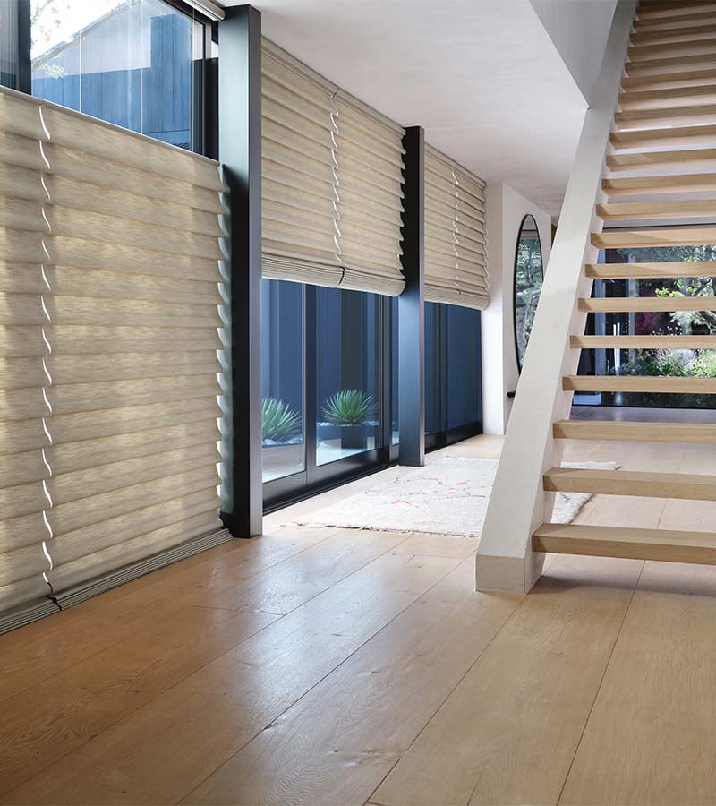 roman shades covering large windows trimmed in black for open air home