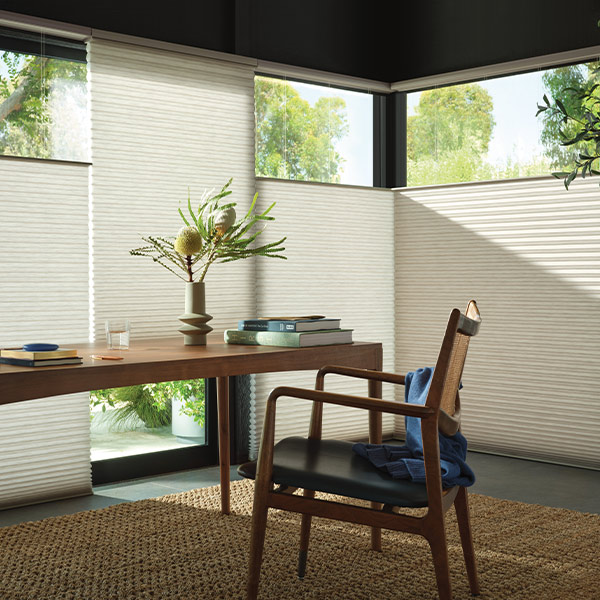 top down honeycomb shades in home office with light entering