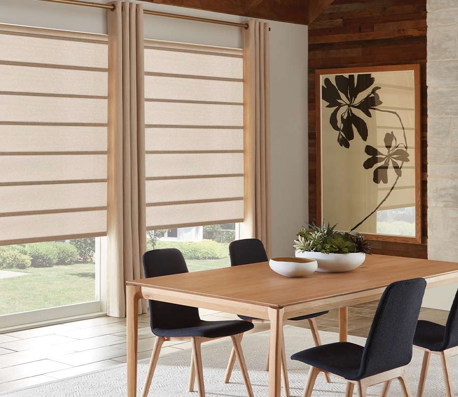 tan custom drapes in dining room with gold drapery rod